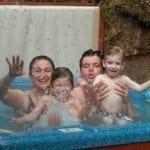 A family enjoying the outdoor hot tub