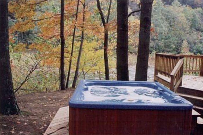 The private outdoor hot tub with a view of the river