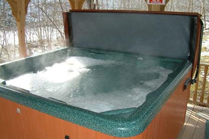 Private outdoor hot tub with steaming water
