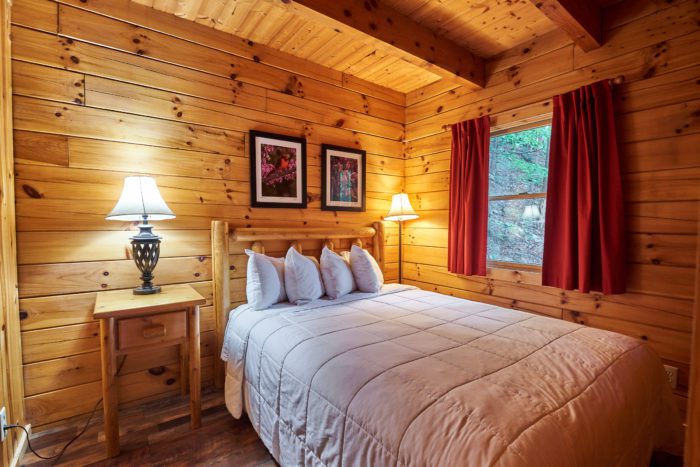 Bedroom in a rustic West Virginia cabin rental at Harman's Luxury Log Cabins.