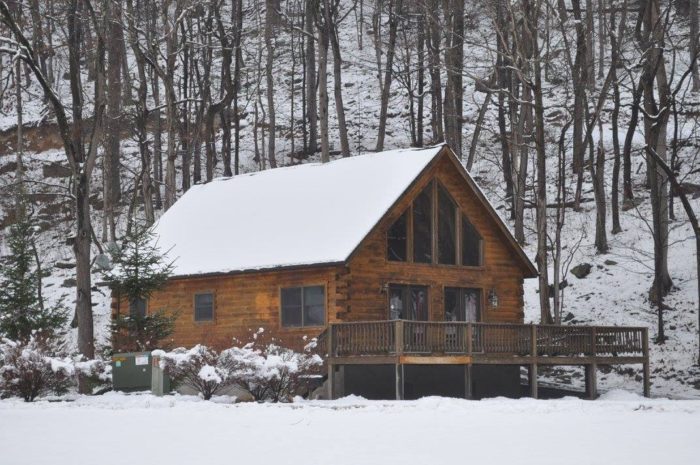 log cabin covered in snow