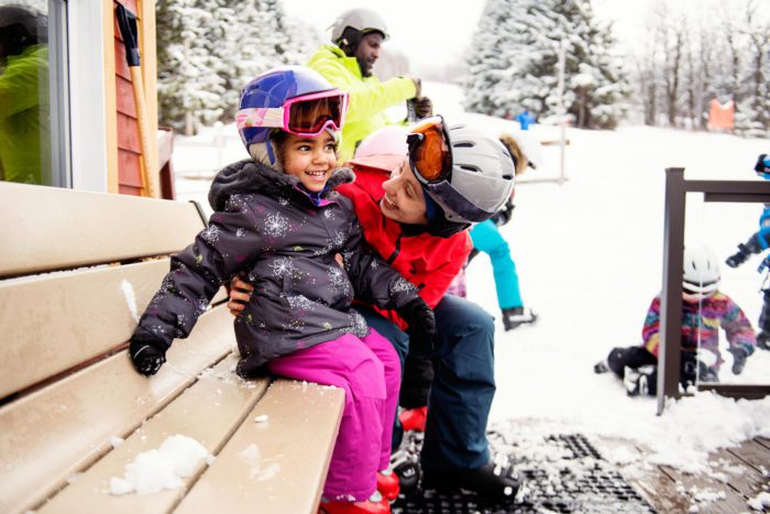 child and mother in ski gear
